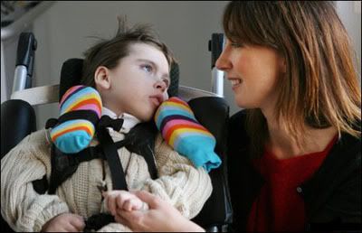 Ivan Cameron helping his Mum open a lift for disabled children - click to go to more pictures on the BBC