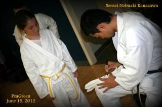 PeaGreen getting his belt autographed by Sensei Nobuaki Kanazawa
