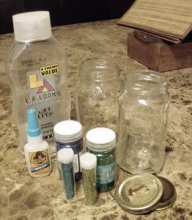 gather your supplies - 2 jars with lids (alfredo sauce if you must know), glitter, hair gel and super glue